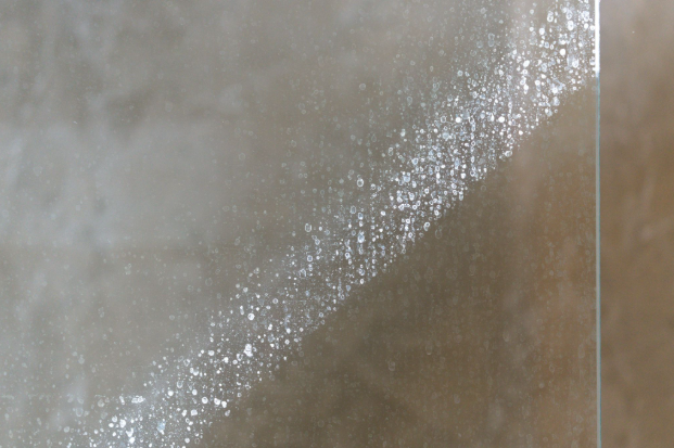 Hard water visible residue on a glass shower.