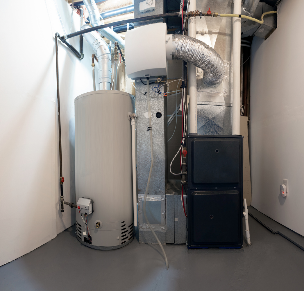 An image of a central heating system setup, showing the water heater and connected ducts, illustrating the components involved in a central heating system installation.